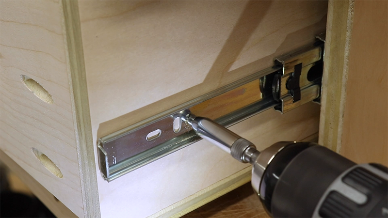 Using a self centering bit to drill pilot holes for the drawer slides